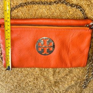Tory Burch orange crossbody or small bag.